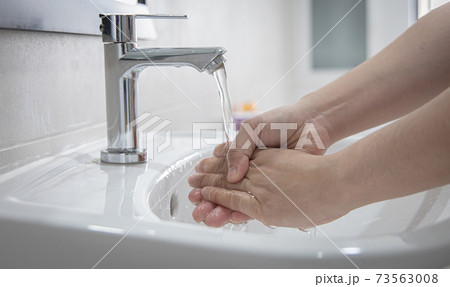 Men are washing their hands in the sinks to clear respiratory bacteria and viruses, sanitation and reduce the spread of COVID-19 that is spread around the world, Hygiene ,Sanitation concept. Men are washing their hands in the sinks to clear respiratory bacteria and viruses, sanitation and reduce the spread of COVID-19 that is spread around the world, Hygiene ,Sanitation concept. 73563008