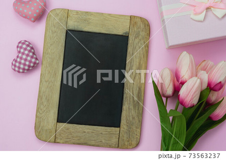 Table top view aerial image of decorations for international women's day  holiday concept background.Flat lay sign of season the word 8 march happy woman's day with flower and gift box on white paper. 73563237