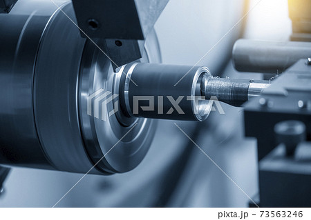 The CNC lathe machine bore cutting the metal shaft. The CNC lathe machine bore cutting the metal shaft. 73563246