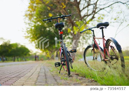two red bicycle parking on street with sunset background two red bicycle parking on street with sunset background 73564557