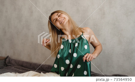 Beautiful smiling blonde in green pajamas. Good morning concept Beautiful smiling blonde in green pajamas. Good morning concept 73564950