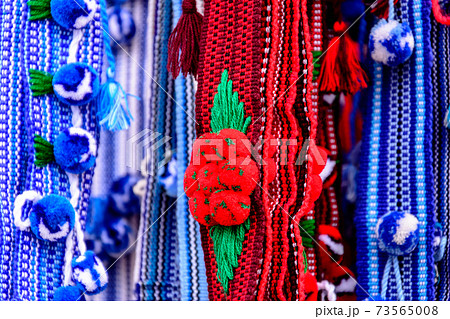 Colorful Ukrainian belts are decorated with embroidery on a shop window 73565008