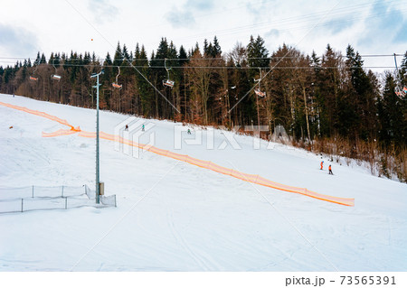 Ski lifts of holiday complexes. In the Carpathians, winter landscape. 73565391