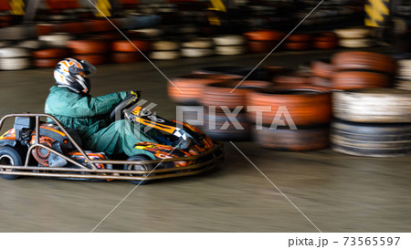 Dynamic karting competition at speed with blurry motion on an equipped racecourse 73565597