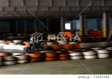 Dynamic karting competition at speed with blurry motion on an equipped racecourse 73565598