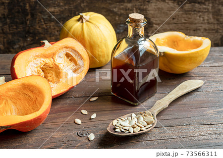 Pumkins and a bottle with pumpkin oil Pumkins and a bottle with pumpkin oil 73566311