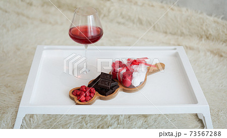 Breakfast for girlfriend. Valentines Day Morning. Wine and sweets on white tray Breakfast for girlfriend. Valentines Day Morning. Wine and sweets on white tray 73567288