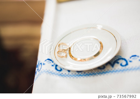 Wedding rings on ceremony at church. Macro. 73567992