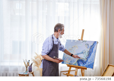 handsome talented painter creating masterpiece 73568198