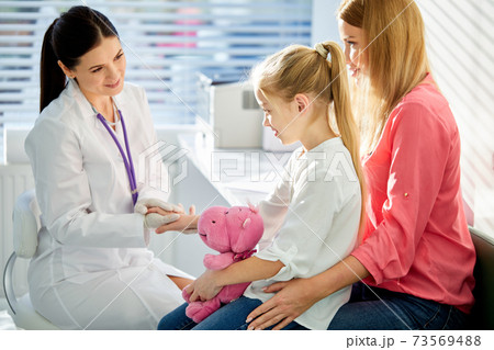 adorable kid girl patient at usual medical inspection checkup 73569488