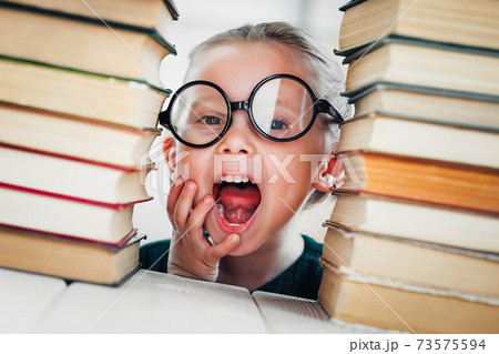 Cute little schoolgirl with books get ready for classes. Inspiring, private or home schooling. Cute little schoolgirl with books get ready for classes. Inspiring, private or home schooling. 73575594