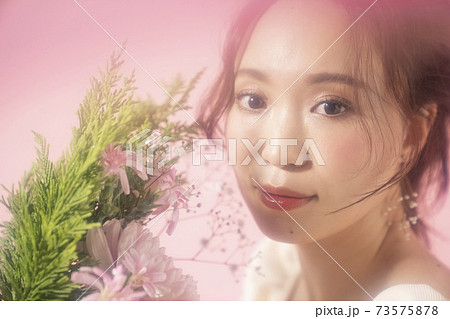花を持つフェミニンな女性のポートレート 花を持つフェミニンな女性のポートレート 73575878
