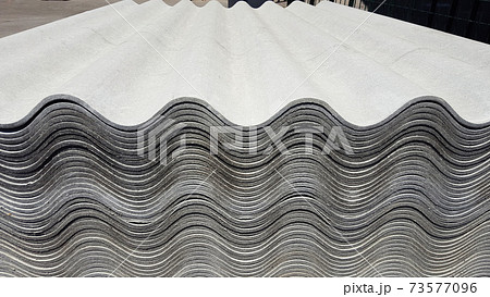 Asbestos roof. Asbestos-cement wave roofing sheets, corrugated panels, stacked on sale 73577096