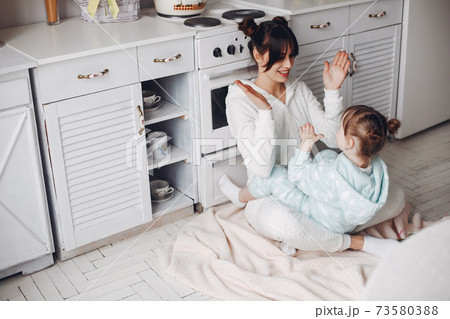 Mother with little daughter in a room 73580388
