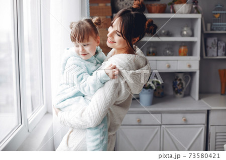 Mother with little daughter in a room 73580421