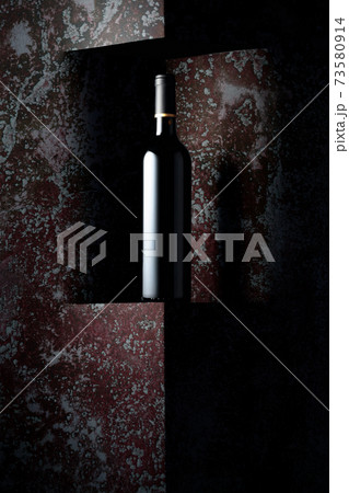 Unopened bottle of red wine on a background of old wall. 73580914