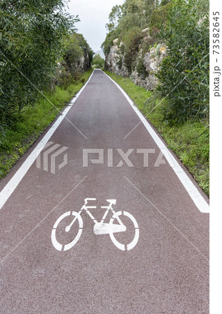 Cycle path with road signs in the woods. Cycle path with road signs in the woods. 73582645