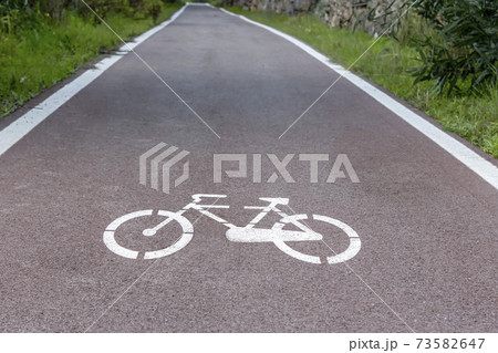 Cycle path with road signs in the woods. Cycle path with road signs in the woods. 73582647