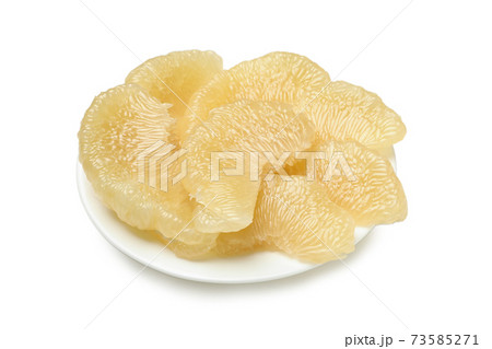 Plate with pomelo fruit slices isolated on white background 73585271