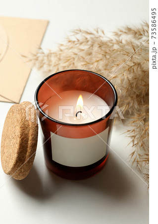 Scented candle, envelope and reed on white background Scented candle, envelope and reed on white background 73586495