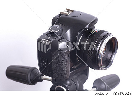 Digital photo camera on black tripod isolated on white background 73586925