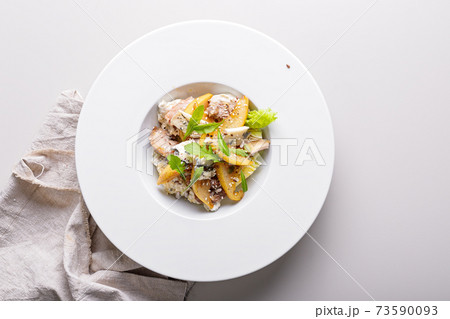 Quick and healthy food recipes. Salad with vegetables, herbs, turkey sous vide meat, caramelized pear, blue cheese with sesame dressing on white plate. Mediterranean dish recipes. Top view. Copy space Quick and healthy food recipes. Salad with vegetables, herbs, turkey sous vide meat, caramelized pear, blue cheese with sesame dressing on white plate. Mediterranean dish recipes. Top view. Copy space 73590093