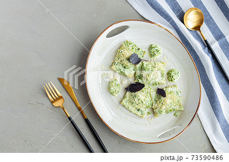 Russian dumpling served with parsley and cheese on plate 73590486