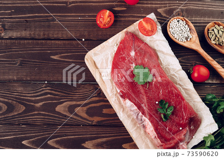 Raw meat beef fillet on brown wooden board Raw meat beef fillet on brown wooden board 73590620