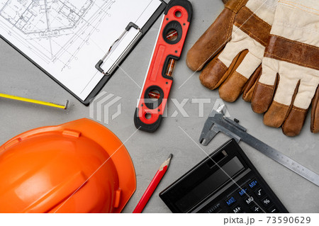 Architect tools hardhat, blueprints and calculator top view Architect tools hardhat, blueprints and calculator top view 73590629
