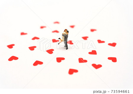 Miniature people standing with Heart shaped red paper. Red heart is the promise of love. as background Valentine concept with copy spaces for your text or design. Miniature people standing with Heart shaped red paper. Red heart is the promise of love. as background Valentine concept with copy spaces for your text or design. 73594661