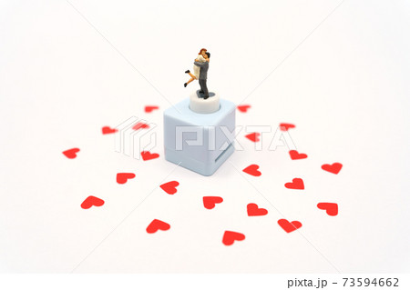 Miniature people standing with Heart shaped red paper. Red heart is the promise of love. as background Valentine concept with copy spaces for your text or design. Miniature people standing with Heart shaped red paper. Red heart is the promise of love. as background Valentine concept with copy spaces for your text or design. 73594662