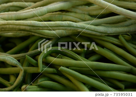 green beans is raw, harvested on wooden background. legumes, vegetarianism and gardening 73595031
