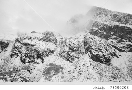 Tatra Mountains at Black Gasienicowy Pond during blizzard, Tatra National Park, Poland. 73596208