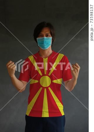 Man wearing hygienic mask and wearing North Macedonia flag colored shirt 73598137