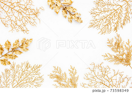 Christmas or new year frame composition. Pattern made of golden leaves on white background. Flat lay, top view, copy space 73598349