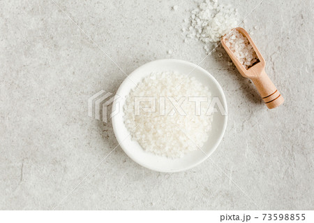Spa skincare concept. Natural Organic spa cosmetics products, sea salt on gray marble table from above. Spa background flat lay, top view. Spa skincare concept. Natural Organic spa cosmetics products, sea salt on gray marble table from above. Spa background flat lay, top view. 73598855