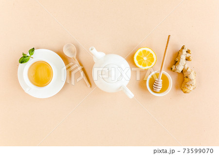 Herbal tea with mint, ginger, lemon, honey and other herbs on yellow background. Flat lay, top view. 73599070