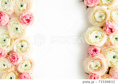 Floral frame borders made of pink ranunculus and roses flower buds on white background. Flat lay, top view floral background. 73599632