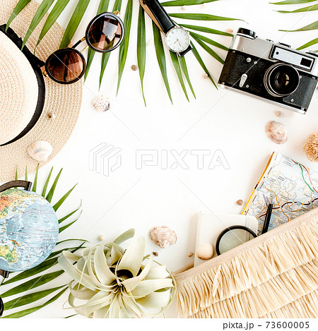 Top view on traveler accessories on white background. Essential vacation items, Travel concept background.  73600005