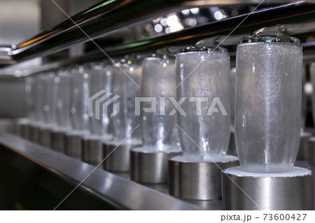 clear glass bottles for medicine, food and beverage product in process of cleaning for hygienic by hot water in automatic glass bottle washing machine at manufacturing. innovation technology and clear glass bottles for medicine, food and beverage product in process of cleaning for hygienic by hot water in automatic glass bottle washing machine at manufacturing. innovation technology and 73600427