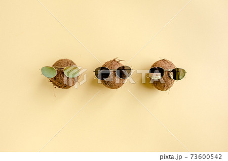 Coconuts on yellow background. The apartment lay, top view Coconuts on yellow background. The apartment lay, top view 73600542