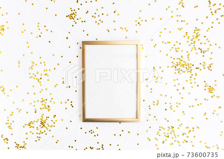 Photo frame mock up with space for text, golden confetti on white background. Lay Flat, top view. Valentine's minimal background. Photo frame mock up with space for text, golden confetti on white background. Lay Flat, top view. Valentine's minimal background. 73600735