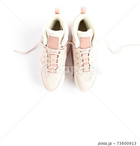 Pink female sneakers on white background. Flat lay, top view minimal background. Fashion blog or magazine concept. Pink female sneakers on white background. Flat lay, top view minimal background. Fashion blog or magazine concept. 73600913