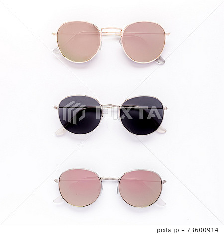 Female sunglasses on white background. Flat lay, top view. Female sunglasses on white background. Flat lay, top view. 73600914
