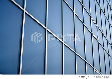 Solid blue windows of the office building. Glass wall Solid blue windows of the office building. Glass wall 73602148