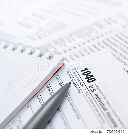 The pen and notebook is lies on the tax form 1040 U.S. Individual Income Tax Return. The time to pay taxes The pen and notebook is lies on the tax form 1040 U.S. Individual Income Tax Return. The time to pay taxes 73602445