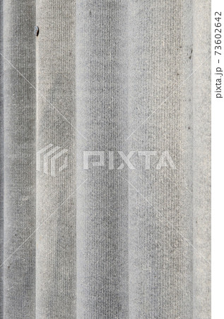 The texture of an old asbestos house roof in a village or an old painted fence of shiver slate The texture of an old asbestos house roof in a village or an old painted fence of shiver slate 73602642