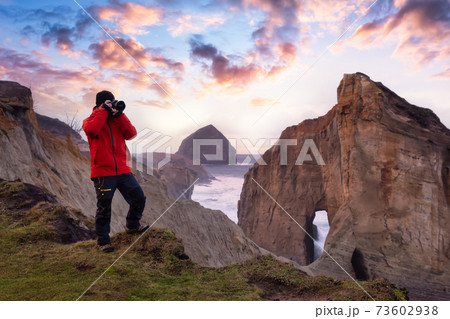 Photographer is taking pictures of the beautiful seaside Photographer is taking pictures of the beautiful seaside 73602938
