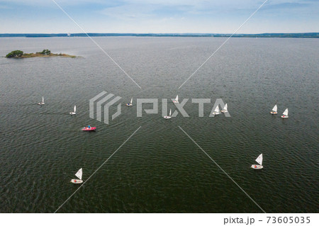 Sailing regatta on the sea. many white sails float on the water 73605035