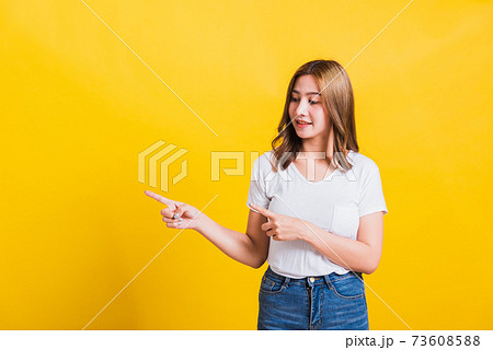 woman teen standing wear t-shirt pointing finger away side 73608588